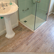 Wood Effect Luxury Vinyl Tiles Fully Prepared and Fitted to a Bathroom and Shower